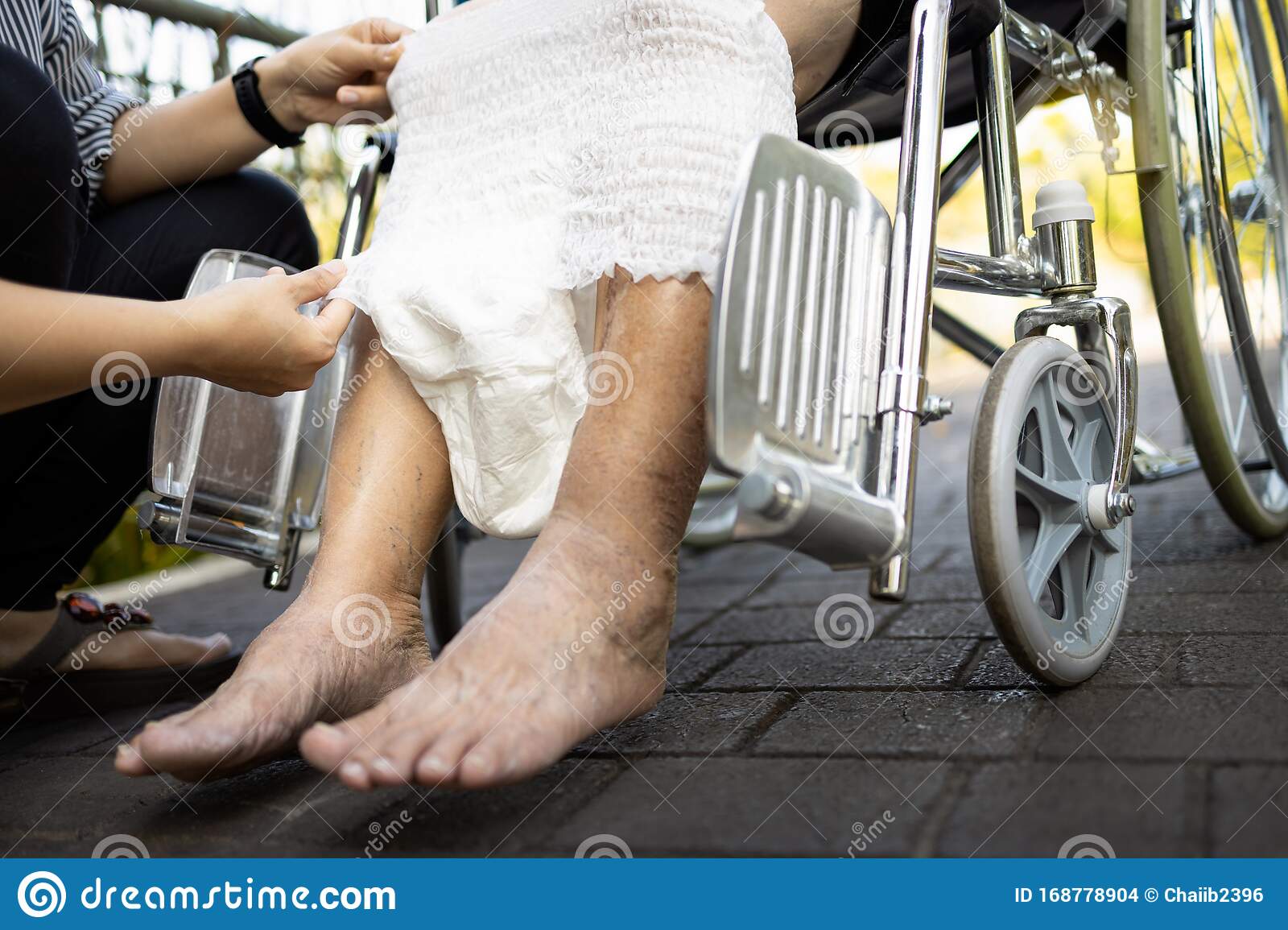 Hand Of Woman Giving Adult Diaper Change At Nursing Home ...